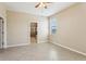 Well-lit bedroom featuring tile floors, a window, and an ensuite bathroom with a glass-enclosed shower at 4976 Creekside Park Ave, Orlando, FL 32811