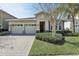 Charming single Gathering home features a two car garage and a meticulously maintained front yard at 4976 Creekside Park Ave, Orlando, FL 32811