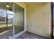 View of the screened patio with sliding glass doors leading into the interior of the home at 4976 Creekside Park Ave, Orlando, FL 32811