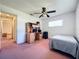 Well-lit bedroom with a ceiling fan, closet, and wooden desk, offering a comfortable space at 515 Spring Oaks Blvd, Altamonte Springs, FL 32714