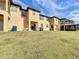 Backyard of condos with covered patios and green space at 569 La Mirage St, Davenport, FL 33897