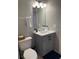 Bathroom features an undermount sink, vanity with storage and modern lighting at 569 La Mirage St, Davenport, FL 33897