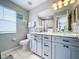 Stylish bathroom featuring modern vanity, mirror, fixtures, and natural light at 569 La Mirage St, Davenport, FL 33897