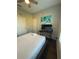 Airy bedroom with a ceiling fan, a minimalist desk, and a scenic wall art at 569 La Mirage St, Davenport, FL 33897