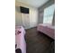 Bedroom featuring two twin beds, a mounted TV and a closet with bi-fold doors at 569 La Mirage St, Davenport, FL 33897