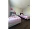Cozy bedroom with two twin beds and delightful pink decor at 569 La Mirage St, Davenport, FL 33897