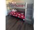 This bedroom features hardwood floors and a gray bunk bed with red Mickey Mouse bedding at 569 La Mirage St, Davenport, FL 33897