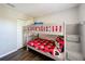This bedroom features hardwood floors and a gray bunk bed with red Mickey Mouse bedding at 569 La Mirage St, Davenport, FL 33897