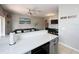 Open-concept kitchen with modern countertops and stainless steel appliances, flowing into the living and dining areas at 569 La Mirage St, Davenport, FL 33897