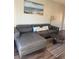 Cozy living room with stylish sectional, and open layout to the dining area at 569 La Mirage St, Davenport, FL 33897