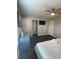 This main bedroom offers wood floors, ceiling fan, and a large decorative headboard at 569 La Mirage St, Davenport, FL 33897