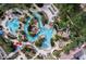 Aerial view of the resort-style pool with lazy river, water slide, and plenty of lounge chairs at 569 La Mirage St, Davenport, FL 33897