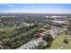 Aerial view of the property surrounded by lush greenery and mature trees in a residential neighborhood at 572 Sanctuary Golf Pl, Apopka, FL 32712