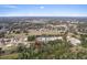 Aerial view of the property featuring a wooded area with residential homes in a Gathering neighborhood at 572 Sanctuary Golf Pl, Apopka, FL 32712
