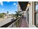 Balcony overlooking a street view with palm trees and seating for relaxing outdoors at 6165 Carrier Dr # 2306, Orlando, FL 32819