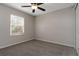 This is an empty bedroom featuring neutral walls, carpet, a ceiling fan, and a window at 6356 Sleepy Hollow Dr, Orlando, FL 32810