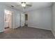 An empty bedroom features neutral walls, carpet, a ceiling fan, and access to the bathroom at 6356 Sleepy Hollow Dr, Orlando, FL 32810