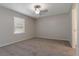 An empty bedroom featuring neutral walls, carpet, a ceiling fan, and a window at 6356 Sleepy Hollow Dr, Orlando, FL 32810