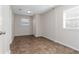 This is an empty bedroom with tile floors, two windows, and a closet at 6356 Sleepy Hollow Dr, Orlando, FL 32810