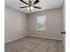Bedroom featuring neutral walls, carpet, a ceiling fan, and a window at 6356 Sleepy Hollow Dr, Orlando, FL 32810