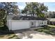 Attractive one-story house featuring attached garage, tidy landscaping, and cozy front porch at 6356 Sleepy Hollow Dr, Orlando, FL 32810