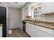 Bright kitchen with white cabinets, stainless appliances, granite counters, and natural light at 6356 Sleepy Hollow Dr, Orlando, FL 32810