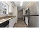 Efficient kitchen design featuring stainless steel appliances, granite counters, and tile floor at 6356 Sleepy Hollow Dr, Orlando, FL 32810