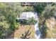This aerial view showcases the home's front yard, mature trees, and ample parking space at 6408 Ridge Ter, Orlando, FL 32810