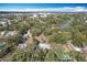 Expansive aerial view of homes surrounded by lush trees and a serene lake at 6408 Ridge Ter, Orlando, FL 32810