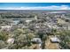 Aerial view showcasing homes nestled amongst mature trees and near a serene pond at 6408 Ridge Ter, Orlando, FL 32810