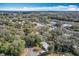 This aerial view showcases the property nestled among lush trees with a view of a nearby lake at 6408 Ridge Ter, Orlando, FL 32810