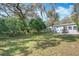 Expansive backyard featuring mature trees, a fire pit, and a seating area at 6408 Ridge Ter, Orlando, FL 32810