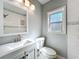 Modern bathroom featuring a vanity, toilet, and window for natural light at 6408 Ridge Ter, Orlando, FL 32810