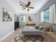 Stylishly staged bedroom features neutral paint, bright natural light, contemporary decor, and tile flooring at 6408 Ridge Ter, Orlando, FL 32810