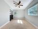 Empty bedroom shows tile flooring, neutral paint, ceiling fan, natural light, and custom closet system at 6408 Ridge Ter, Orlando, FL 32810