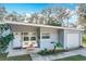 Inviting front porch features seating and a stylish entrance to this charming home at 6408 Ridge Ter, Orlando, FL 32810