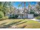 Charming single-story home with a manicured lawn and lush landscaping, including a central palm tree at 6408 Ridge Ter, Orlando, FL 32810