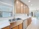 Kitchen featuring stainless steel sink, white subway tile backsplash, wooden cabinets, and marble countertops at 6408 Ridge Ter, Orlando, FL 32810