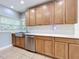 Kitchen featuring stainless steel appliances, white subway tile backsplash, marble countertops, and wooden cabinets at 6408 Ridge Ter, Orlando, FL 32810