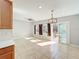 Open concept living and dining area features neutral paint, tile floors, updated lighting, and outdoor access at 6408 Ridge Ter, Orlando, FL 32810