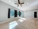 Bright and spacious living area with tile flooring, modern lighting, and access to an outdoor patio at 6408 Ridge Ter, Orlando, FL 32810
