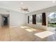 Sunlit living room features neutral paint, tile floors, ceiling fan, and a sliding glass door to the exterior at 6408 Ridge Ter, Orlando, FL 32810