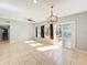 Bright living area featuring tile floors, neutral paint, ceiling fan, modern light fixture, and access to the yard at 6408 Ridge Ter, Orlando, FL 32810