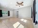 Expansive living room featuring tile flooring, neutral tones, and ample natural light from large windows at 6408 Ridge Ter, Orlando, FL 32810