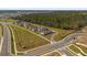 New home construction aerial view showcasing residential lots, green spaces, and street layout in a growing community at 6895 Botanic Blvd, Harmony, FL 34773