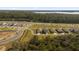 Primary-planned community aerial view with new homes, green spaces, and scenic roadways, providing an attractive residential environment at 6895 Botanic Blvd, Harmony, FL 34773