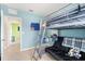 Inviting bedroom with bunk bed, futon, and cheerful blue walls at 6895 Botanic Blvd, Harmony, FL 34773