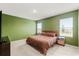 Cozy bedroom features a comfortable queen bed, two windows, and neutral carpeting at 6895 Botanic Blvd, Harmony, FL 34773