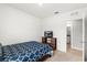 Comfortable bedroom with neutral carpet, television, and attached bathroom for convenience at 6895 Botanic Blvd, Harmony, FL 34773