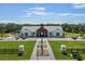 Community clubhouse with manicured lawn, ample parking, and modern architectural design at 6895 Botanic Blvd, Harmony, FL 34773